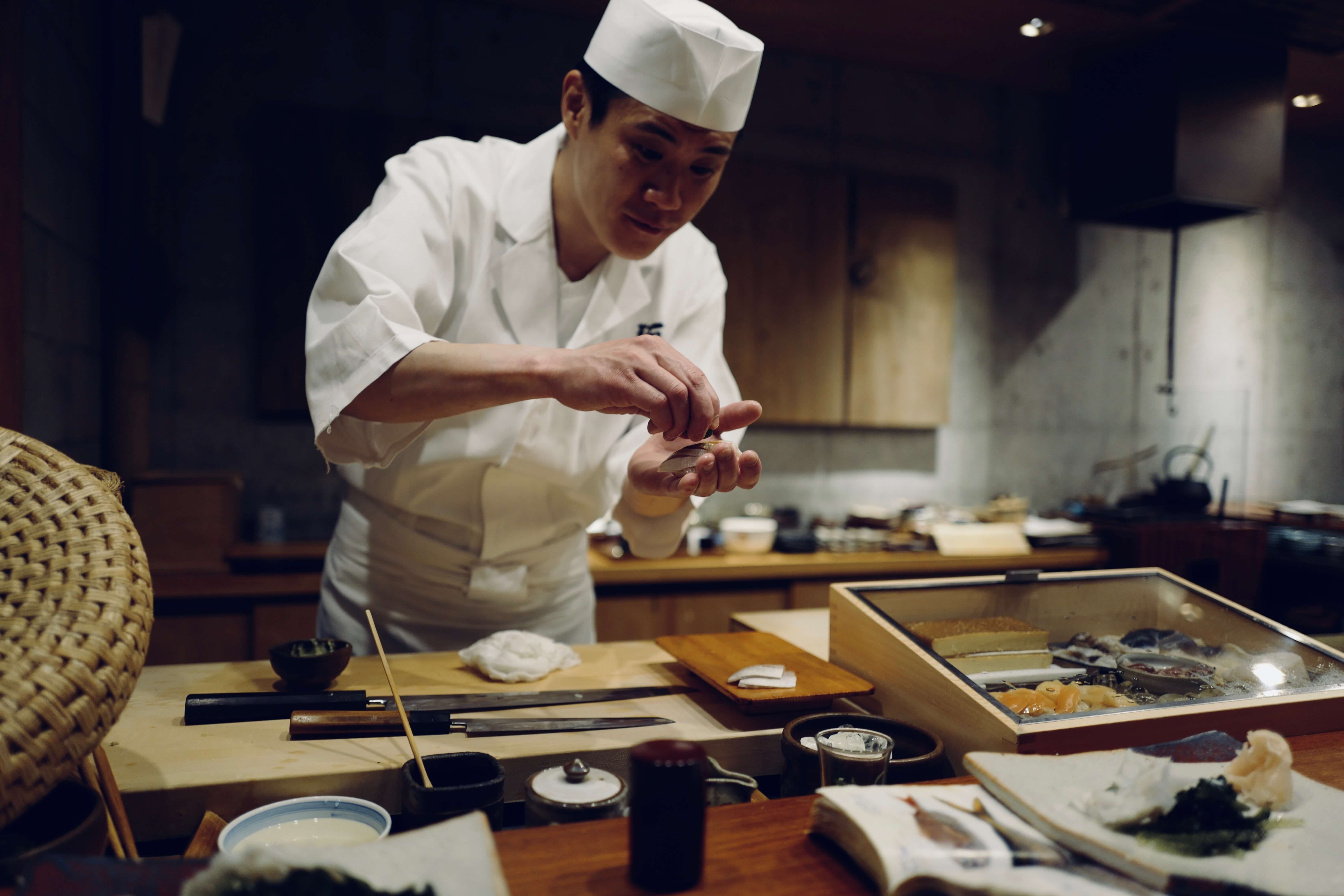 Sushi chef at authentic sushi shop in Japan